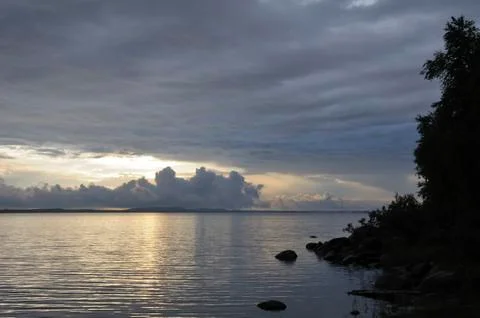 Distant rainstorm clouds over lake Stock Photos