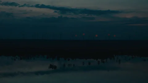 Distant red lights on wind turbines glowing against a dark twilight sky. Stock Footage 299895193