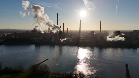 Distant river view of smoking industrial shoreline Stock Footage 331204562