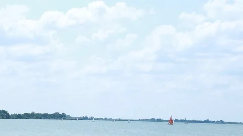 Distant Sailboats Gliding on Calm Summer Lake 動画素材 334885232