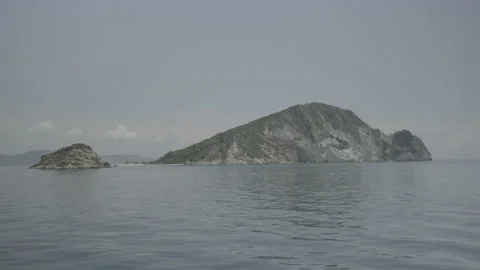 Distant scenic view of the turtle-shaped island of Marathonissi Stock Footage 238779979