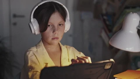 Distant School Learning Concept. Girl in Headphones Uses Tablet Computer Stock Footage 252969877