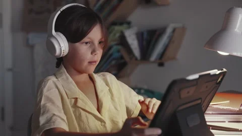 Distant School Learning Concept. Girl in Headphones Uses Tablet Computer Stock Footage 253647831