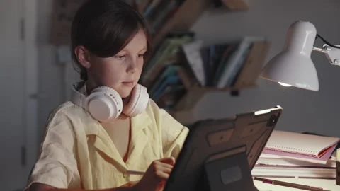 Distant School Learning Concept. Girl in Headphones Uses Tablet Computer Stock Footage 254552133