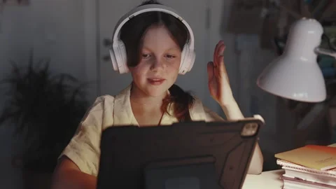Distant School Learning Concept. Girl in Headphones Uses Tablet Computer Stock Footage 254552196