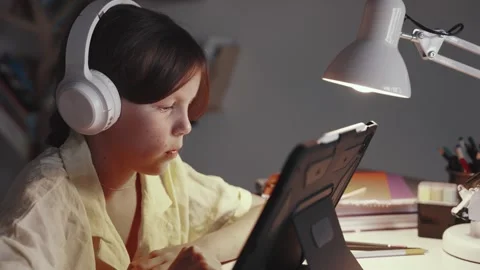 Distant School Learning Concept. Girl in Headphones Uses Tablet Computer Stock Footage 254684906