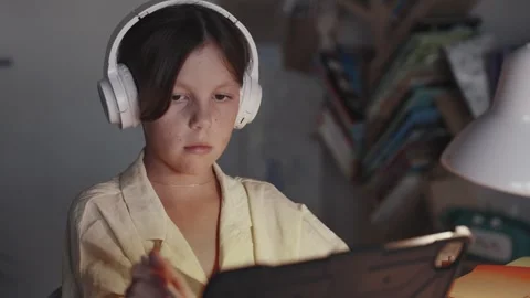 Distant School Learning Concept. Girl in Headphones Uses Tablet Computer Stock Footage 256815870