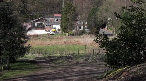 Distant shot of car passing house near forest pool Stock Footage 62362103