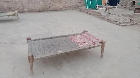 Distant Side View of a Traditional Pakistani Charpai Video stock 347341487