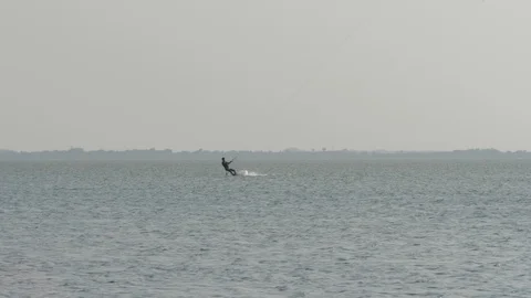 Distant silhouette practices board edge riding slow motion Stock Footage 118992836