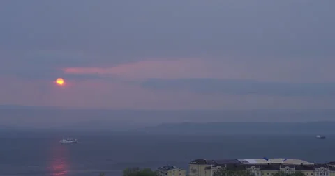 Distant single vessel drifts slowly on peaceful water Видео 320042302