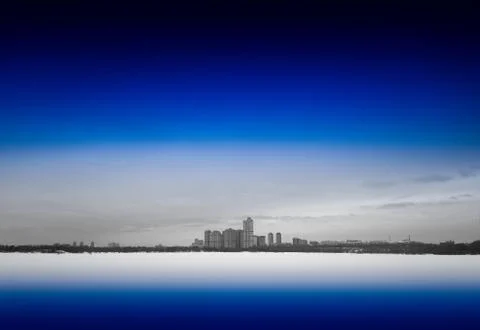 Distant skyscrapers on smooth river background Foto stock