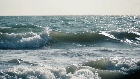 Distant slow motion view of small turquoise waves building before storm v3 Stock Footage 119534746