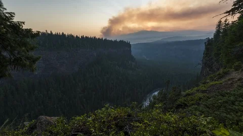 Distant smoking forest fire time lapse from canyon wall 4K Stock Footage 107959393