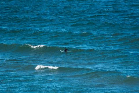 A distant solitude surfer on extreme cold Lake Superior at Great Sand Bay Stock Photos