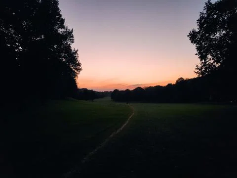 Distant Storm Clouds Over Park and Nature 库存照片