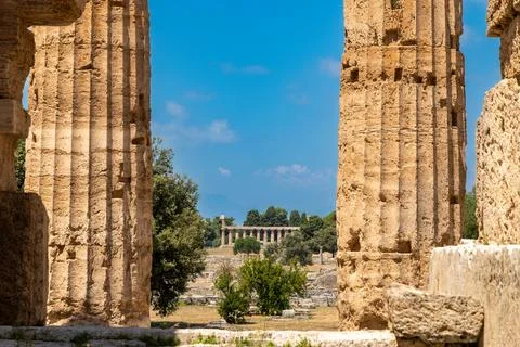 Distant temple view framed by ancient stone columns 库存照片