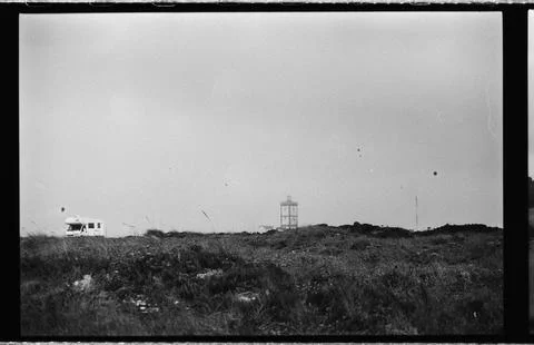 Distant Tower and Camper Beneath Open Sky Stock Photos