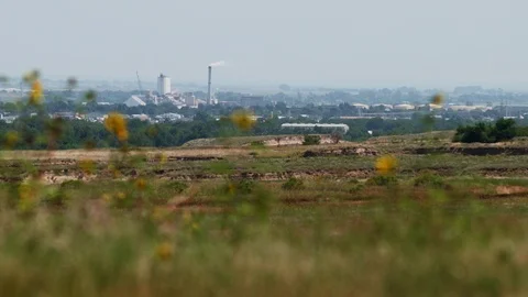 A distant town with smoke stacks Stock Footage 86920569