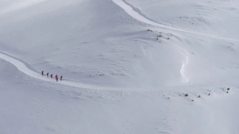 Distant view aerial of pro athletes cross-country skiing in winter New Zealand Stock Footage 121584240