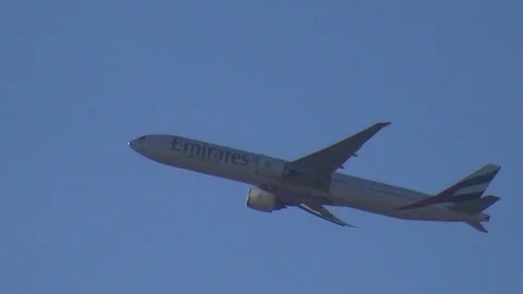 Distant view of an aircraft during flight of EMIRATES company 스톡 동영상 127609339