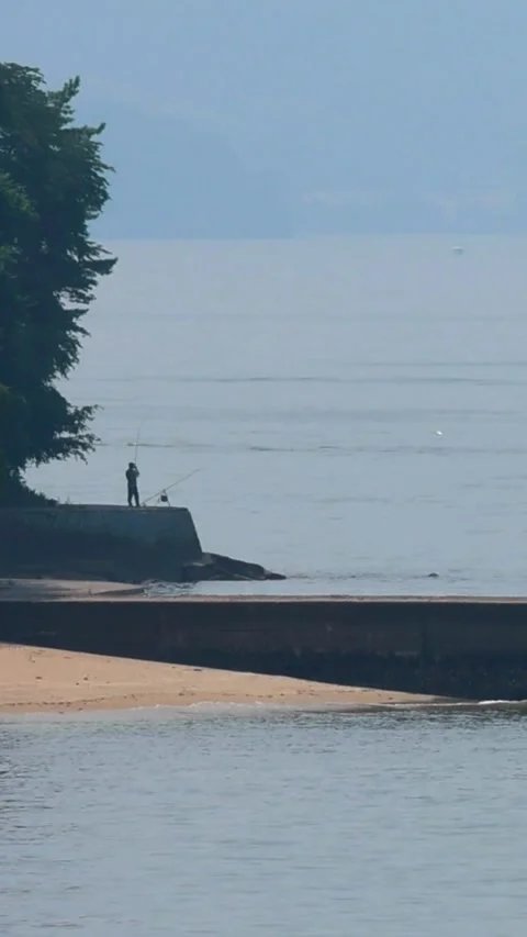 Distant View of an Angler on the Coast of Moto-Ujina near Hiroshima Port, 02 库存影片 340766391