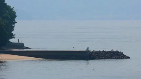 Distant View of an Angler on the Coast of Moto-Ujina near Hiroshima Port, 4K 库存影片 340766457