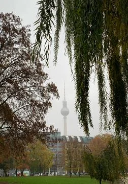 Distant view of Berlin TV tower in foggy day during autumn in Berlin, Germany. Stock Photos