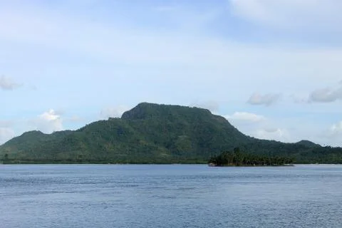Distant view of a Big and small island at sunset Stock Photos