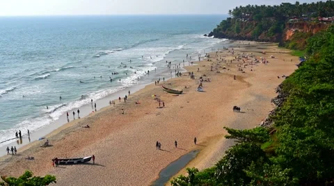 Distant view of blue sea, waves, sand and tourists on Varkala Beach. Varkala bea Video stock 61833210