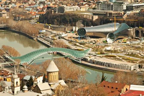 Distant view of the Bridge Of Peace across Kura river in old Tbilisi, Georgia Stock Photos