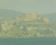 Distant view of castle and island hillside from sea SD Footage