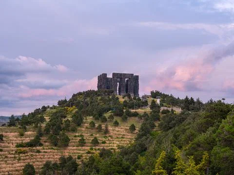 Distant view of the Chronicle of Georgia monument on a hill at sunset Stock Photos