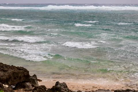 A distant view of the clear waves and reefs of Ike Island Stock Photos