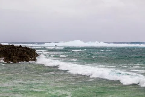 A distant view of the clear waves and reefs of Ike Island Stock Photos