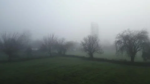 Distant view of a country house in the fields in a foggy morning Stock Footage 264056262