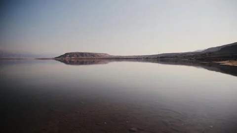Distant view of Dead Sea shore near Ein Bokek, Israel. Sandy beach with clear Stock Footage 273913771