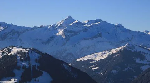 Distant view of the Diablerets mountain range and glacier on a winter day. Stock Photos