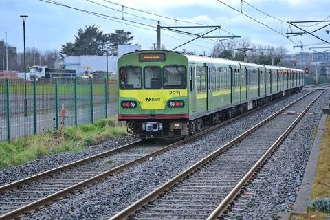 Distant view of entire DART train in action at Blackrock train station Stock Photos