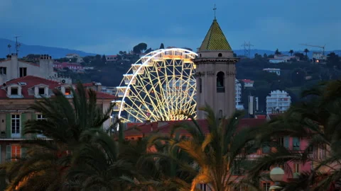 Distant view of a ferris wheel along the Mediterranean coast of the city in the Stock Footage 304276746