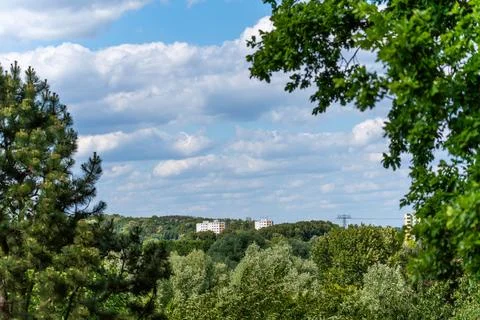 A distant view of forest, clouds, and residential buildings on the horizon. Fotos de archivo