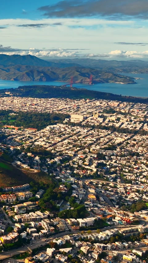Distant view of Golden Gate Bridge over a residential San Francisco hillside Stock Footage 342274421