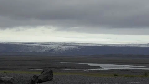 Distant View of an Icelandic Glacier Over a Vast Volcanic Landscape Stock Footage 339957228