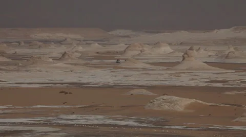 Distant view of  jeeps crossing the White Desert, Egypt Stock Footage 36119107