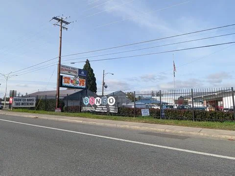A distant view of the Josephine County Fairgrounds sign shows fencing Stock Photos