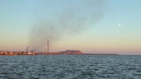 Distant view of the large Azovstal foundry with smoking pipes at sunset Stock Footage 183530500