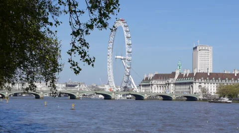Distant view of London eye big wheel across the riverbank Stock Footage 37244749