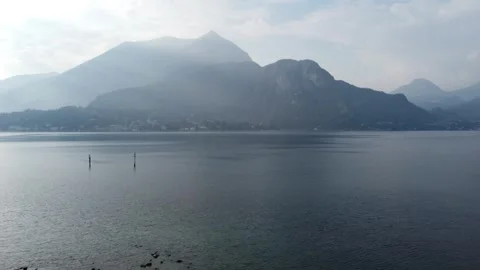 Distant View of Menaggio across Lake Como with Morning Light Rays Stock Footage 313563106
