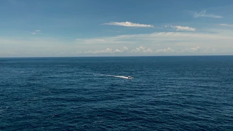 Distant view of motor boat sailing alone in the sea slomo Stock Footage 125842207