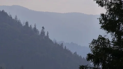 Distant view of the mountains. Mountain slopes in the fog. Video stock 75167919